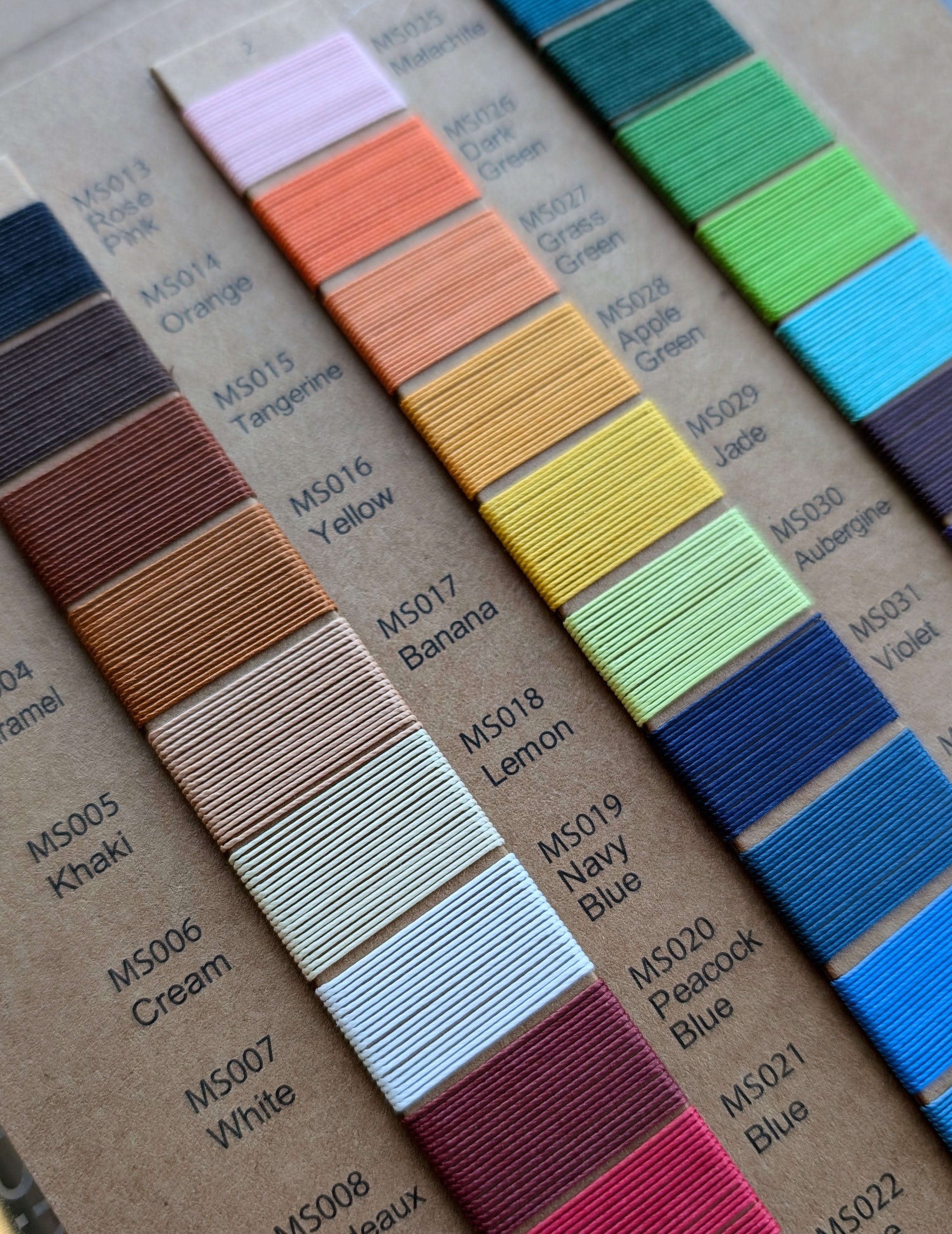 Color swatch chart with various colors on a cardboard background