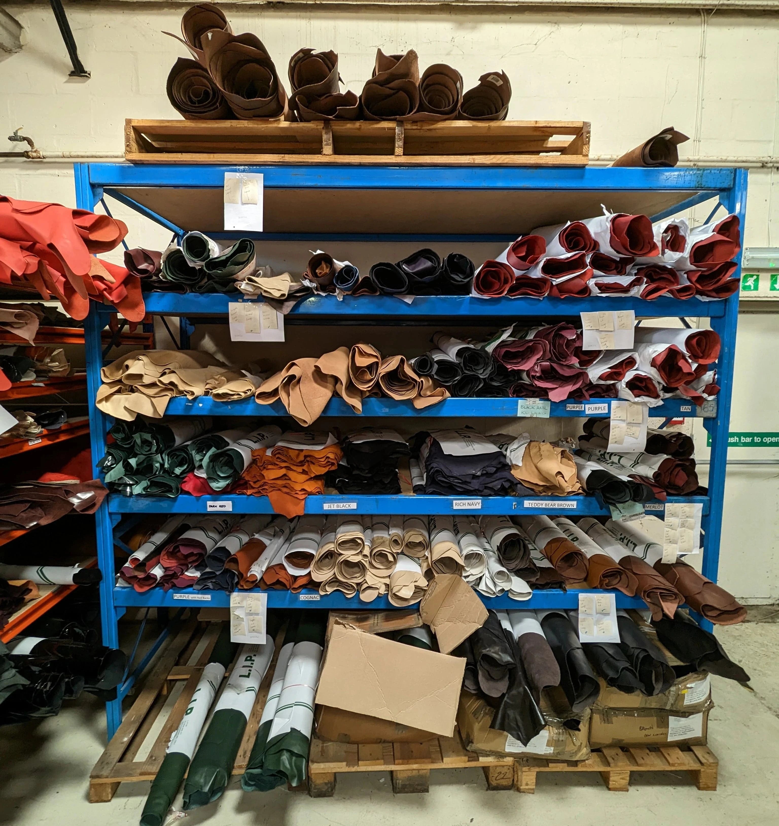 A storage shelf holding rolls of different leathers and materials