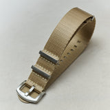Beige watch strap with silver buckle on a light gray background