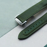 Green watch strap on a light gray background