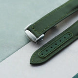 Green watch strap on a light gray background