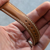 close up of tan brown watch strap with white stitching 